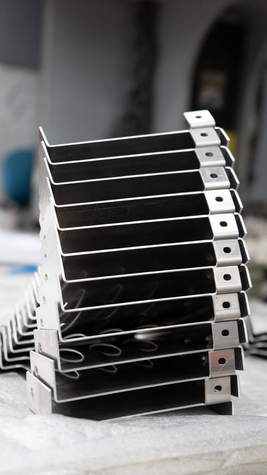 Finished powder-coated brackets stacked ready for assembly