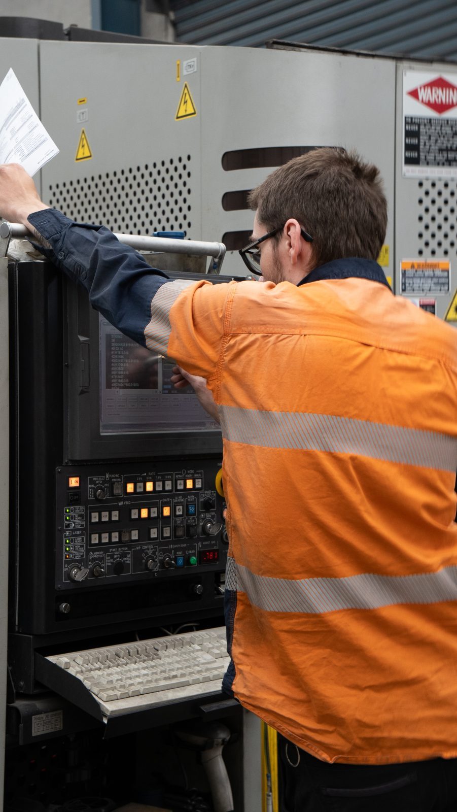 Amapro operator at the laser cutting machine controls