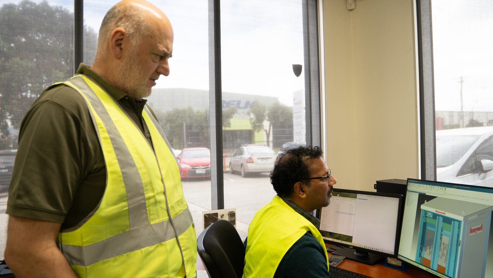 Amapro team reviewing fabrication drawings at a workstation