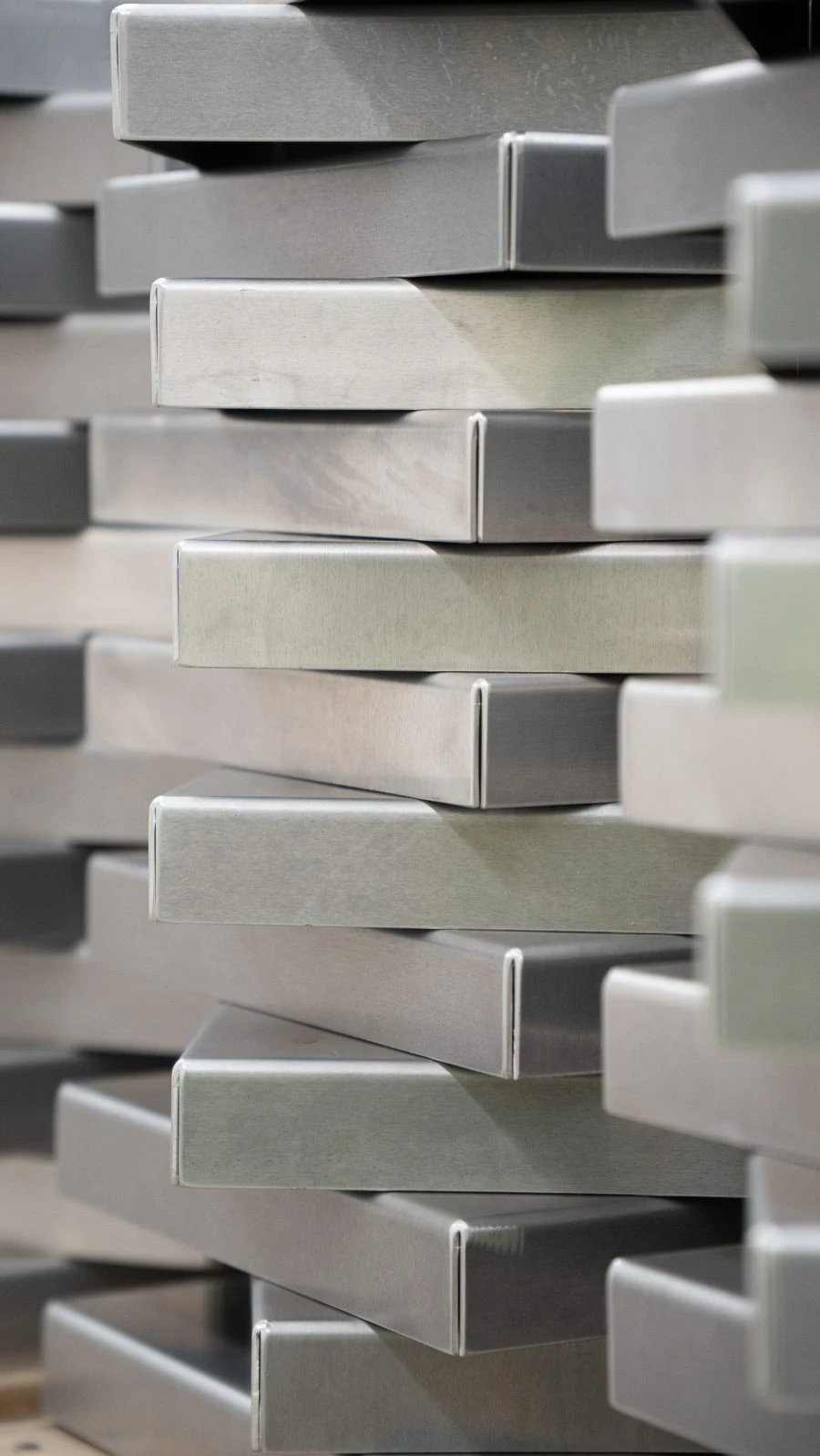 A close-up view of stacked rectangular metal bars, arranged in a staggered formation.